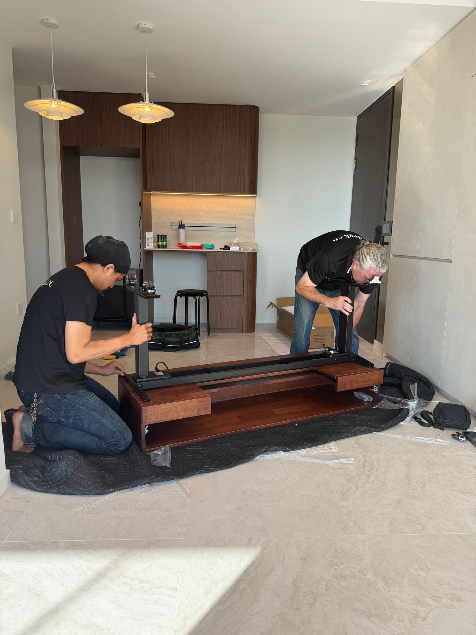 Custom Desk SG team installing a desk in a customer's home
