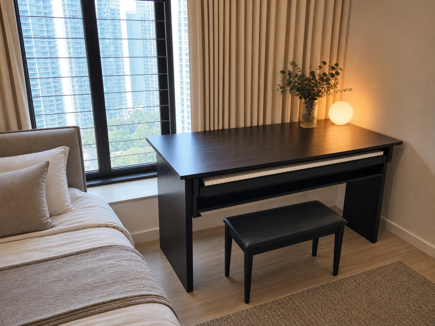 Black piano studio desk beside a bed and broad window ledge in a city bedroom