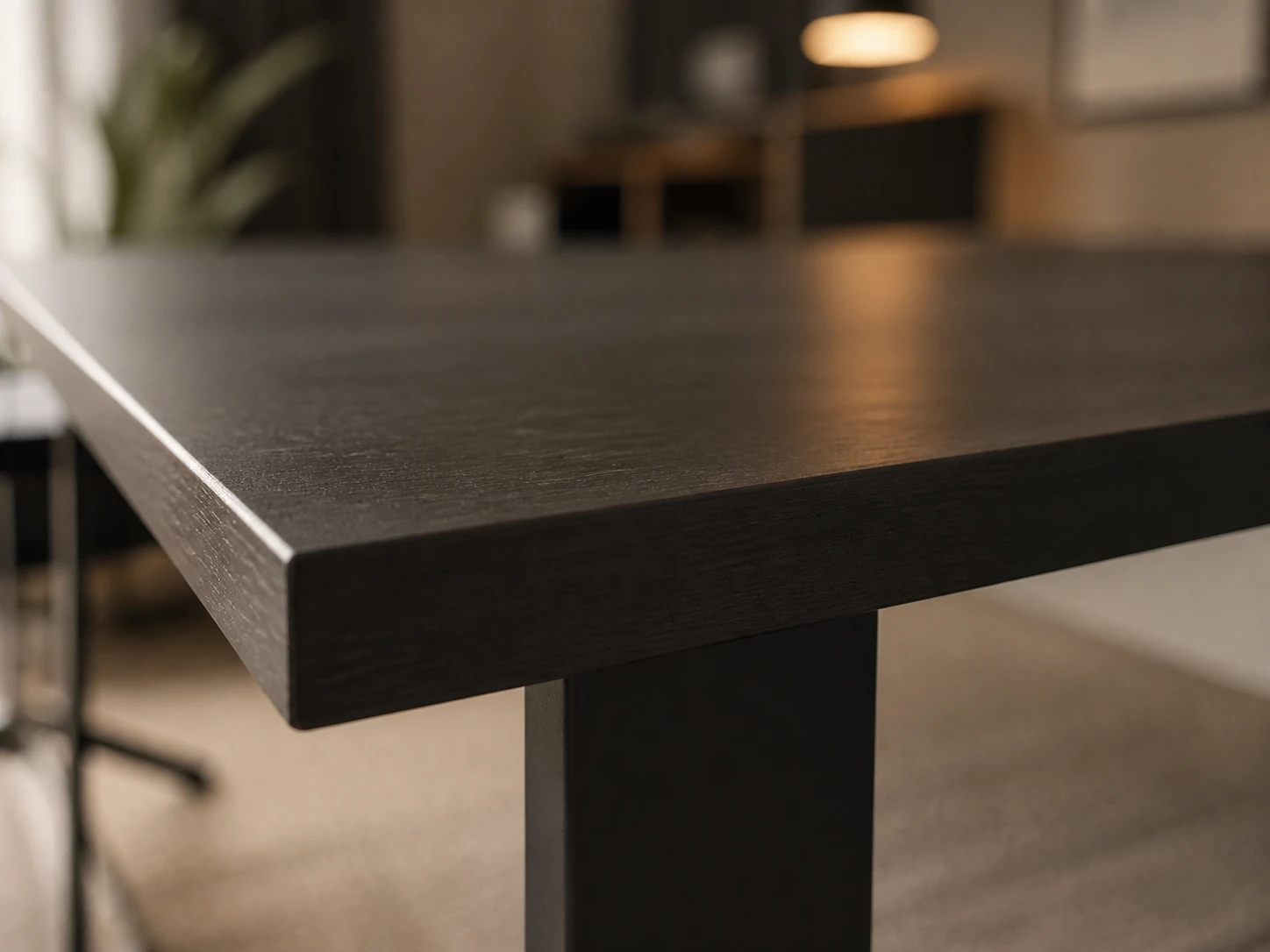 Close detail of a black-finished solid-wood tabletop with a clean square edge