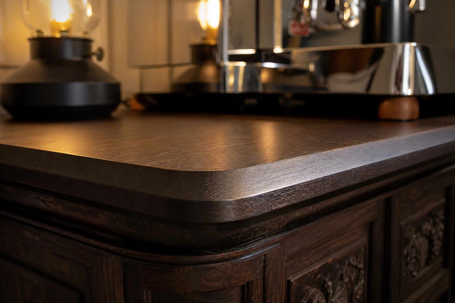 Close detail of a dark-stained solid-wood tabletop with a crisp flat chamfered edge